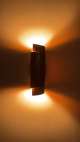 Arcus brass ribbon wall sconce video showing tall curved shade design, warm up-down glow, side ambient lighting, and wall-mounted installation