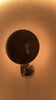 Brussels wall light video displaying the large curved disc shade, blackened brass finish and atmospheric glow from different angles