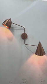 Lisbon dual shade solid brass wall sconce video showing copper patina finish, movable arms, dome and cone shades, and warm focused lighting for stylish interiors