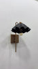 Sculptural ruffled bedside wall sconce with matte black shade, elongated brass stem and warm downward glow