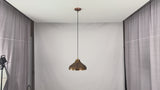 Video of solid copper dome pendant light showing artistic copper finish, black cord, warm downward glow, and elegant kitchen island installation