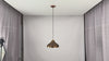 Video of solid copper dome pendant light showing artistic copper finish, black cord, warm downward glow, and elegant kitchen island installation