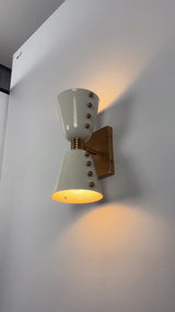 Luma Diabolo 2-light wall sconce video showing solid brass cone shades, warm up-down glow, and decorative brass details