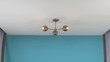 Video of handcrafted brass 3-light chandelier by Brass Leaf Studio – mid-century modern ceiling fixture with warm ambient glow, rotating view and lighting in action