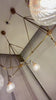 Linear 6-light ribbed glass globe chandelier video showing brass frame, chain suspension, warm glow, and luxury dining room lighting effect