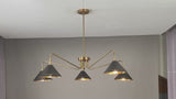 Mid-century brass chandelier with cone shades shown illuminated and rotating in room setting