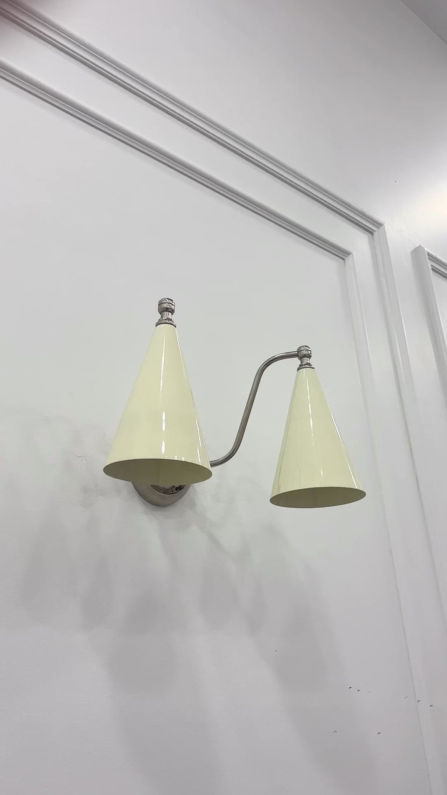Mid century inspired Delphi wall light with symmetrical twin shades and compact chrome wall mount