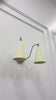 Delphi 2 light wall sconce video showing the ivory enamel cone shades, polished chrome brass arms, 15 inch width and warm downward illumination