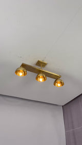 Solid brass 3-light semi flush mount ceiling fixture video showing linear bar, dome shades, and warm downward lighting effect