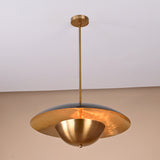 Angled side view of handmade brass ceiling light featuring two contrasting domes and minimalist industrial styling