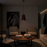 Closeup of red copper pendant shade showing textured patterned surface and warm copper-toned decorative finish