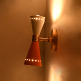 Retro solid brass wall lamp with two diabolo shades creating decorative upward and downward glow