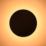 Top view of round bowl brass ceiling light glowing with warm illumination