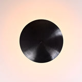 Top view of blackened brass bowl ceiling light showing circular uplight pattern