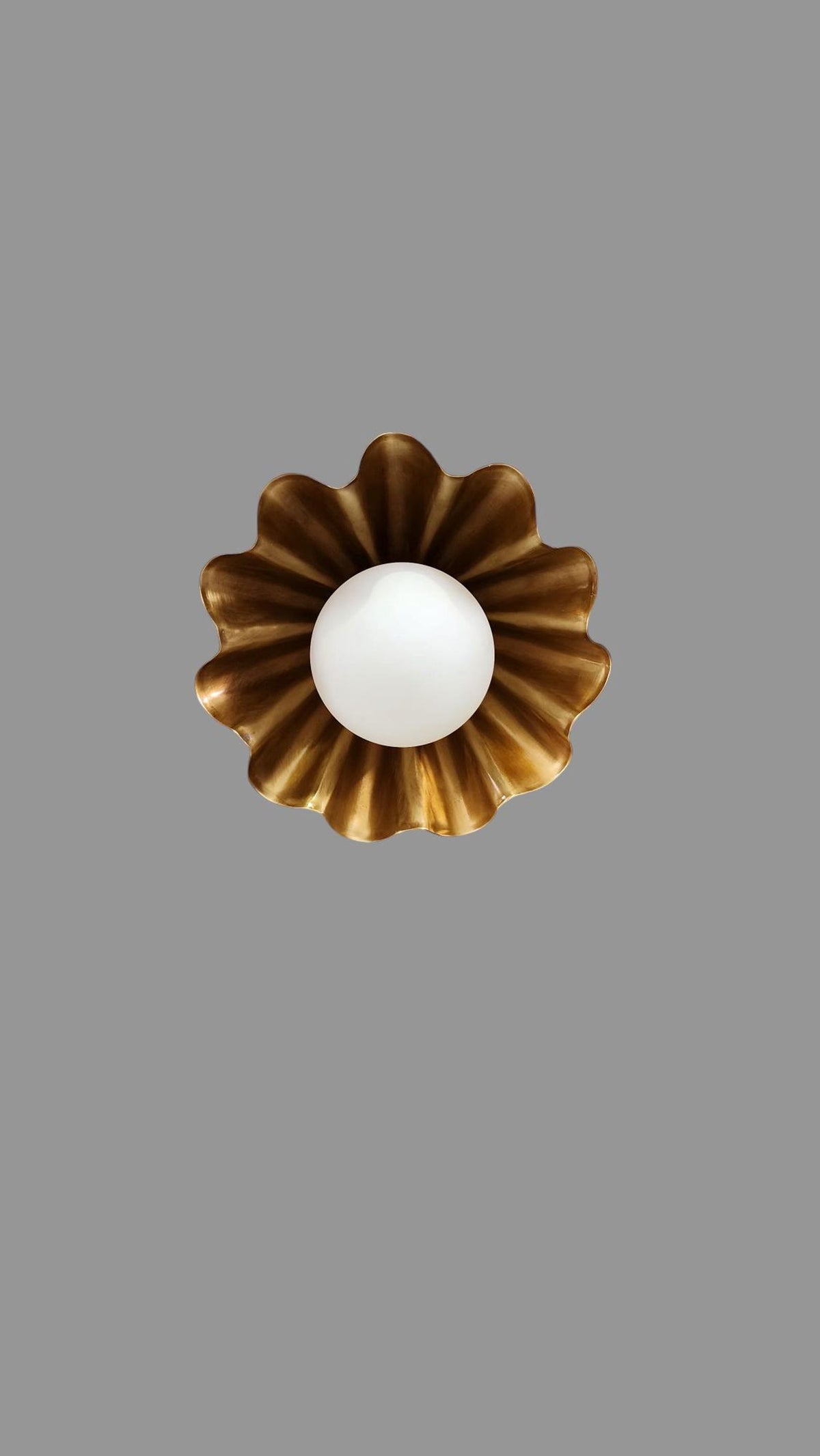 Top view of handmade ruffled brass flushmount ceiling light with round globe center