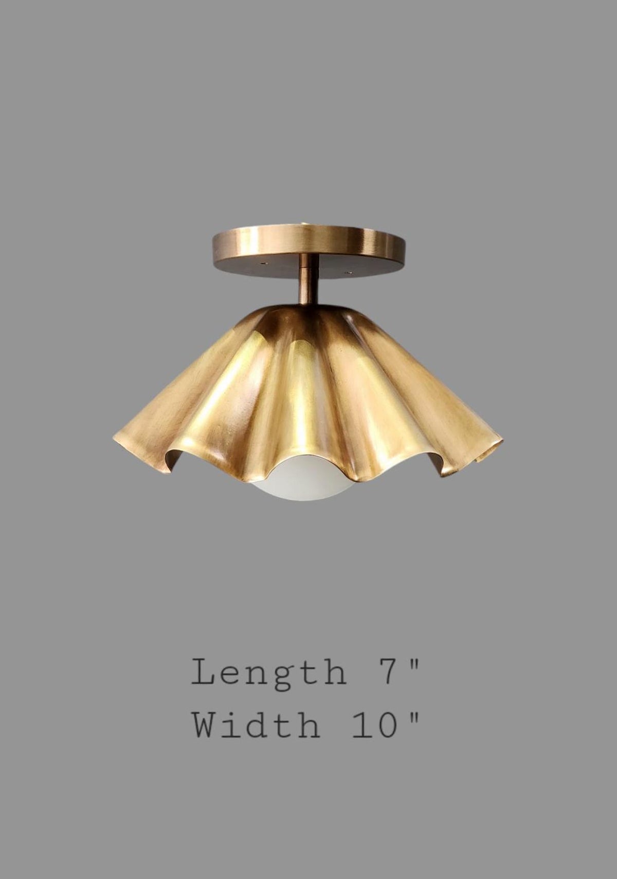 Ruffled brass flushmount ceiling light with 10 inch width and 7 inch height