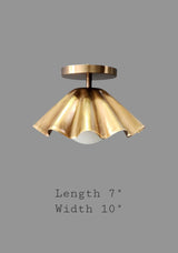 Ruffled brass flushmount ceiling light with 10 inch width and 7 inch height