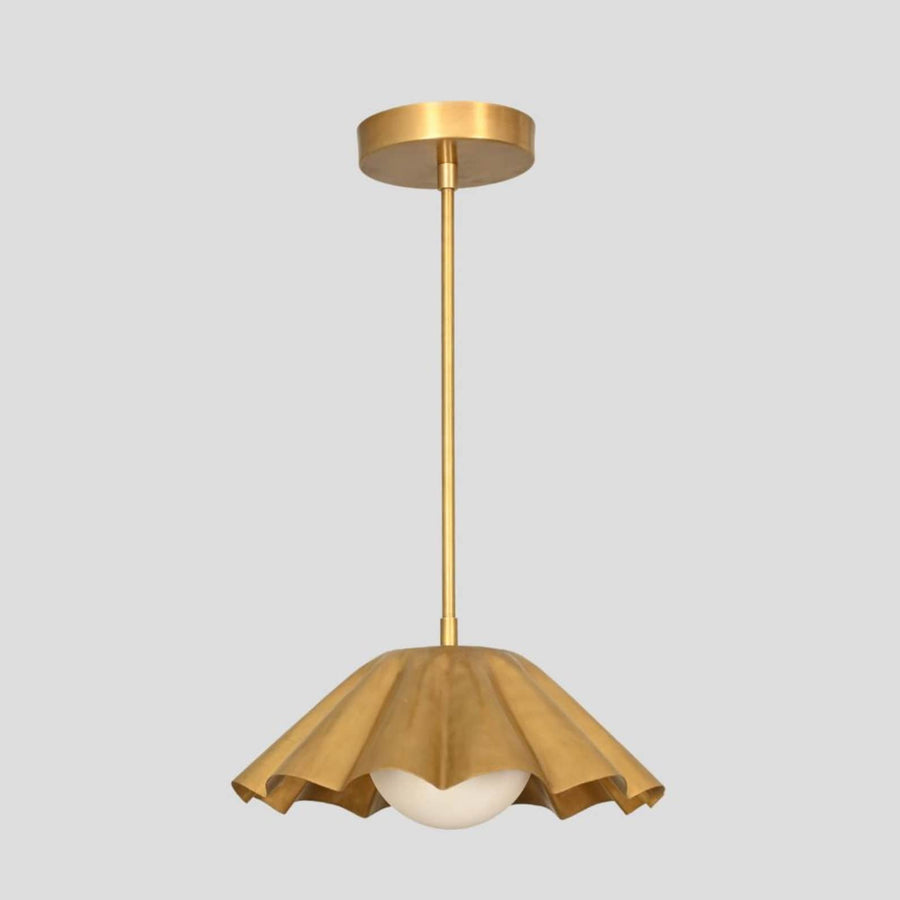 Handmade ruffled brass pendant light with sculptural dome shade and opal globe bulb, designed by Brass Leaf Studio for modern interiors.