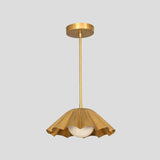 Elegant brass pendant lamp with pleated ruffled dome and white globe shade, perfect for dining rooms, living spaces, and boutique interiors.