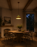 Rustic copper dome pendant light hanging above a kitchen island, creating warm focused lighting for dining and cooking spaces