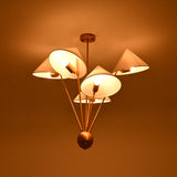 Sculptural five light chandelier with angled white fabric shades and elegant raw brass construction