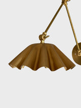 Close-up of scalloped brass shade with fluted folds and warm brushed finish.