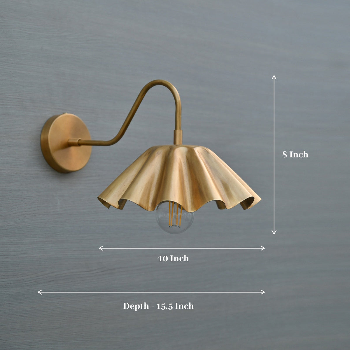 Brass wall sconce with scalloped fluted shade showing dimensions – 8 inch height, 10 inch width, 15.5 inch depth