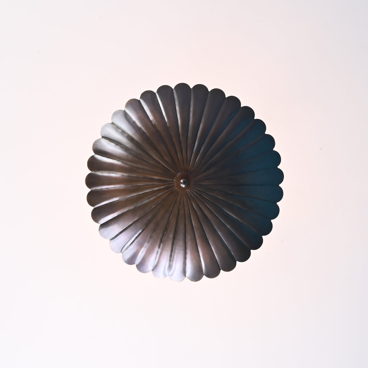 Brass ceiling mount and stem detail of scalloped disc pendant light