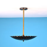 Side angle view of handcrafted scalloped brass pendant light with pleated disc shade