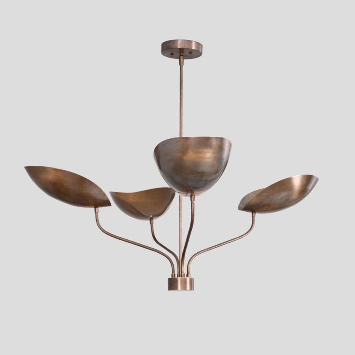 Sculpted brass chandelier featuring four bowl shades on curved arms, elegant modern handmade lighting fixture.
