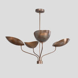 Sculpted brass chandelier featuring four bowl shades on curved arms, elegant modern handmade lighting fixture.