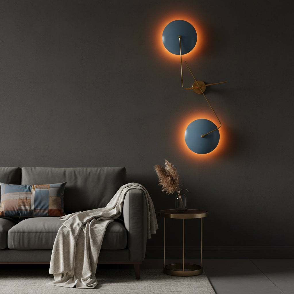 Sculptural blue disc wall sconce shown illuminated with warm halo lighting behind two circular shades