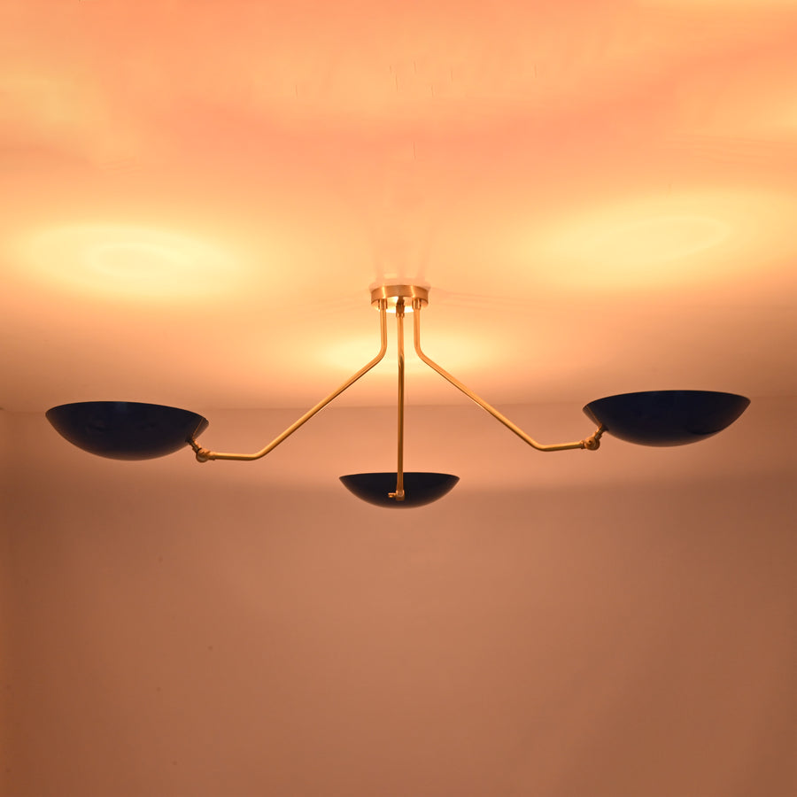 Modern three-light flush mount ceiling light with blue bowl shades and brushed brass arms by Brass Leaf Studio