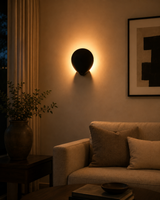 Sculptural solid brass wall sconce with petal-shaped front shade for modern accent lighting
