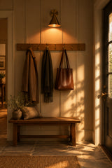 Lacquer coated brass cone sconce with warm patina finish and elegant wall mounted profile