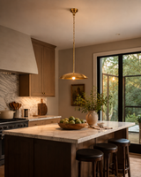 Single light brass pendant for breakfast nook with minimalist dome shade and warm downward lighting effect