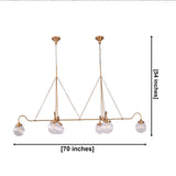Six-light linear chandelier with ribbed clear glass globes, brass arms, dual ceiling canopies, and chain suspension