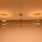 Six-light linear chandelier shown illuminated with broad warm lighting for large rooms and dining tables