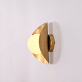Solara crescent globe wall sconce shown in office interior with warm ambient wall glow