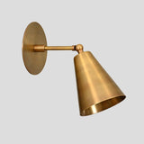 Solid brass adjustable wall sconce with cone shade, durable handcrafted industrial wall lighting.