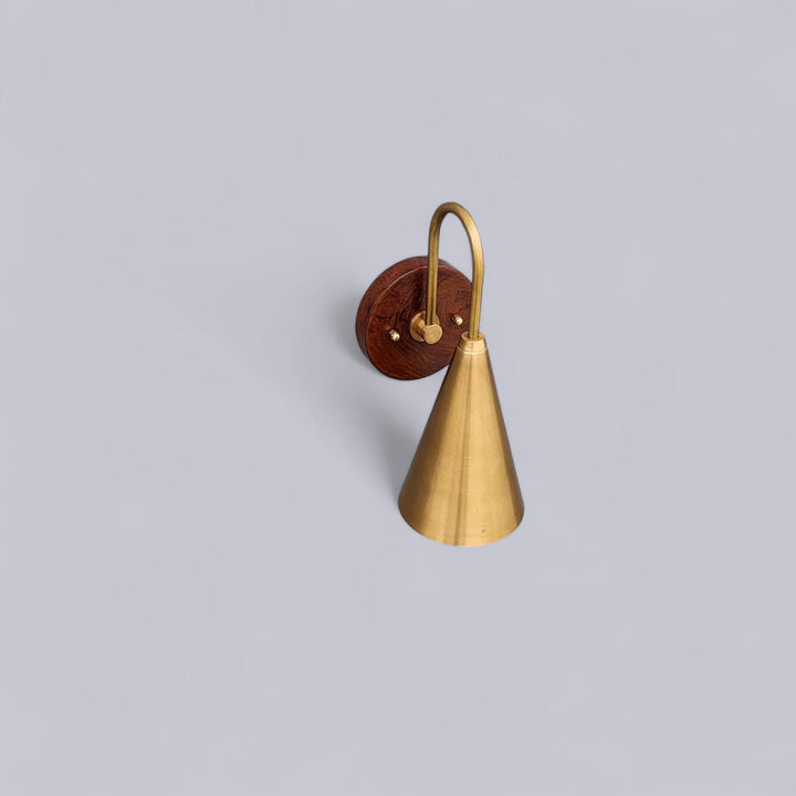 Overhead view of solid brass and wood wall light showcasing the refined texture and craftsmanship of Brass Leaf Studio.