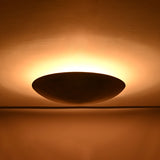 Solid brass bowl flush mount ceiling light shown from front with warm indirect lighting effect