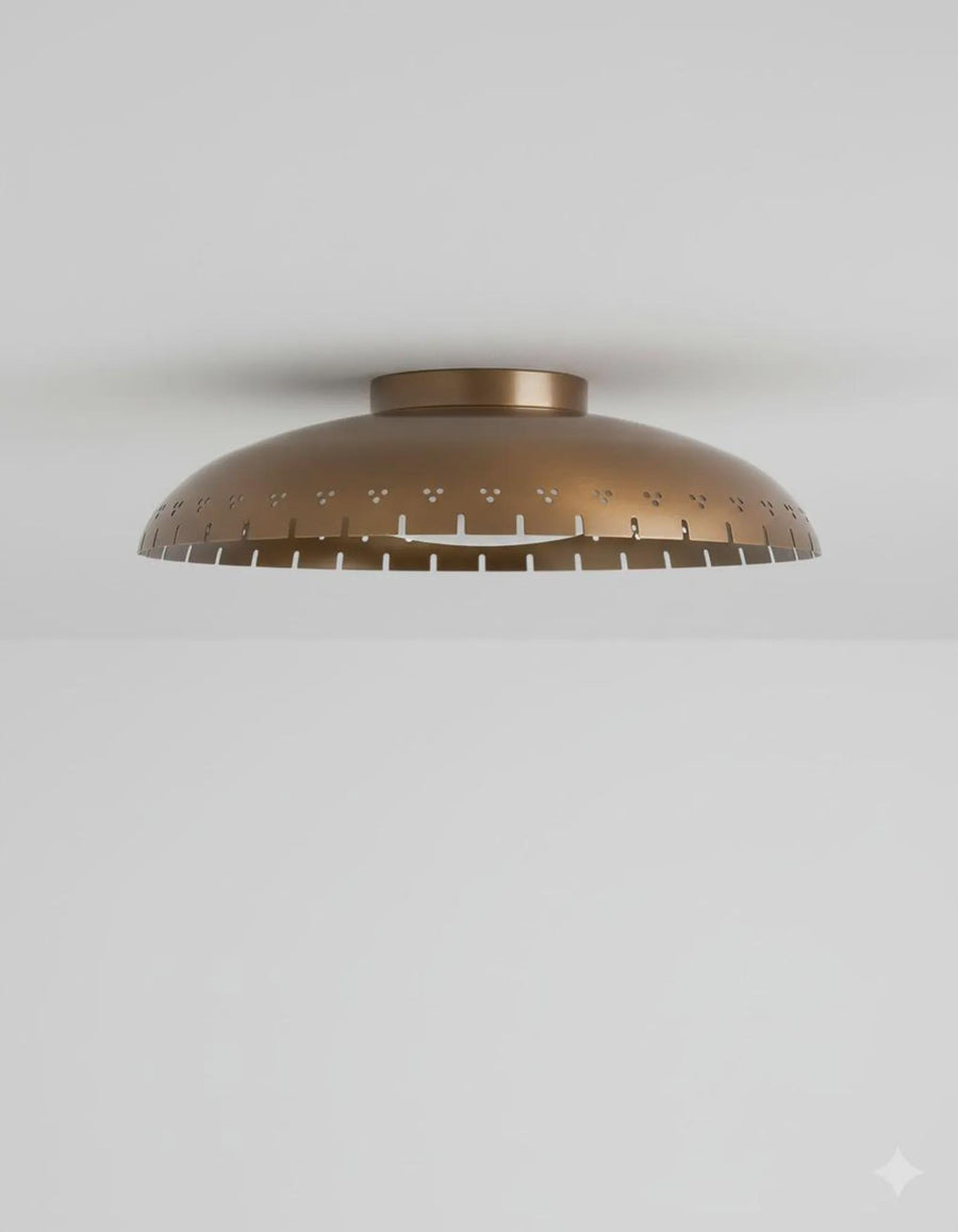Brushed brass bowl flush mount ceiling light with disc glass globe providing warm ambient lighting in a modern interior