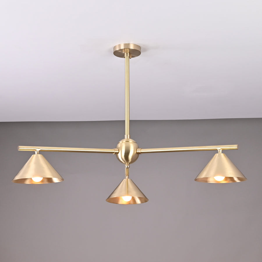 Modern solid brass chandelier with three cone-shaped shades, brushed finish, handcrafted for contemporary interior lighting.