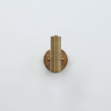 Solid brass cylinder wall light with focused downward glow, ideal for bedside reading and hallway lighting