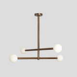Solid brass modern chandelier featuring four globe lights in a minimalist industrial style.