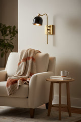 Solid brass reading wall light with curved arm, vertical support, rectangular backplate, and black brass sheet shade