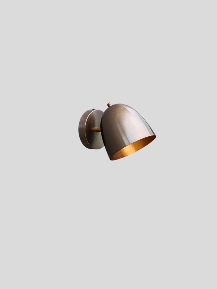 Solid brass wall lamp featuring bowl-shaped shade and brushed patina finish, handmade by Brass Leaf Studio