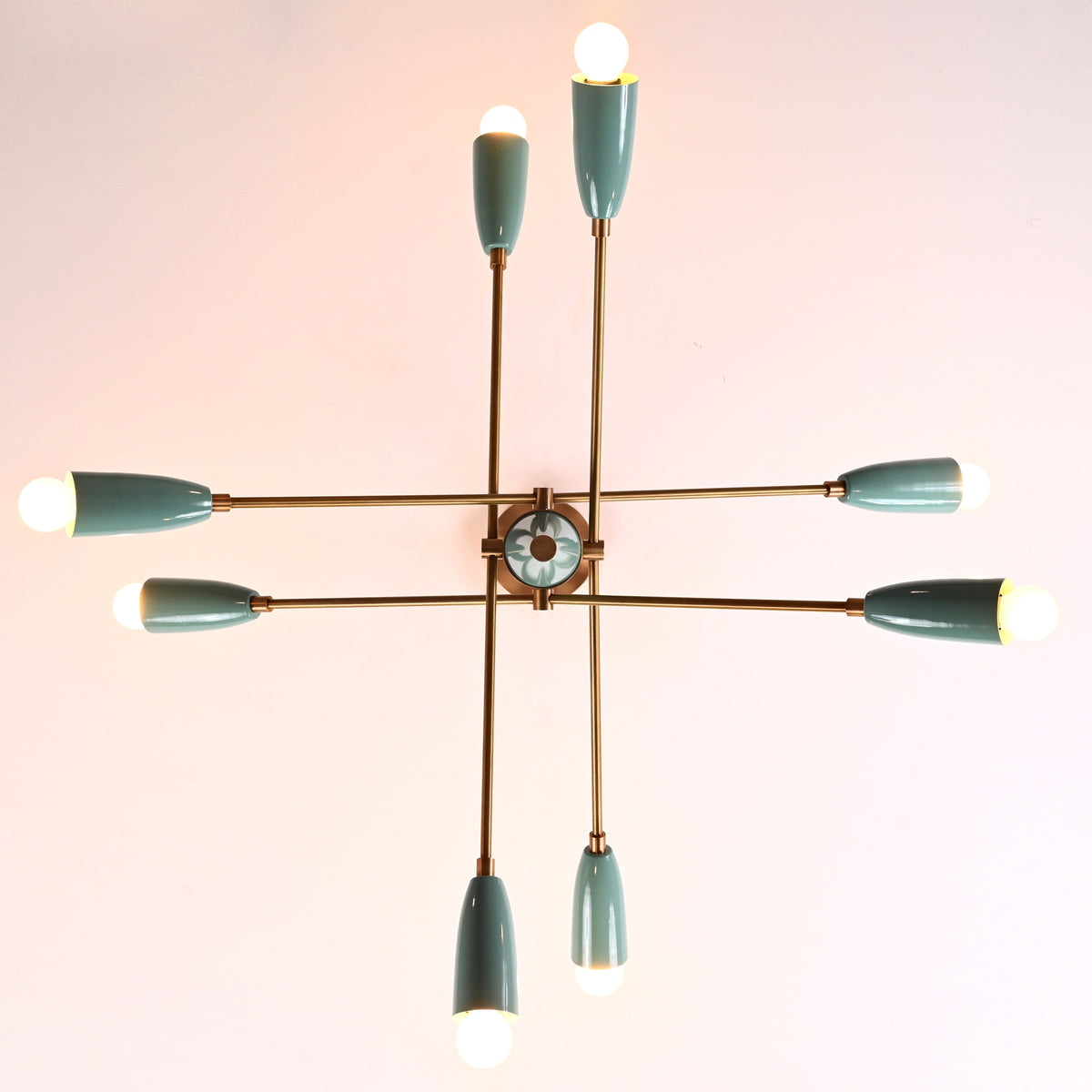 Top-down view of 8-light Sputnik chandelier with teal cone shades and brass arms, mid-century modern ceiling fixture.