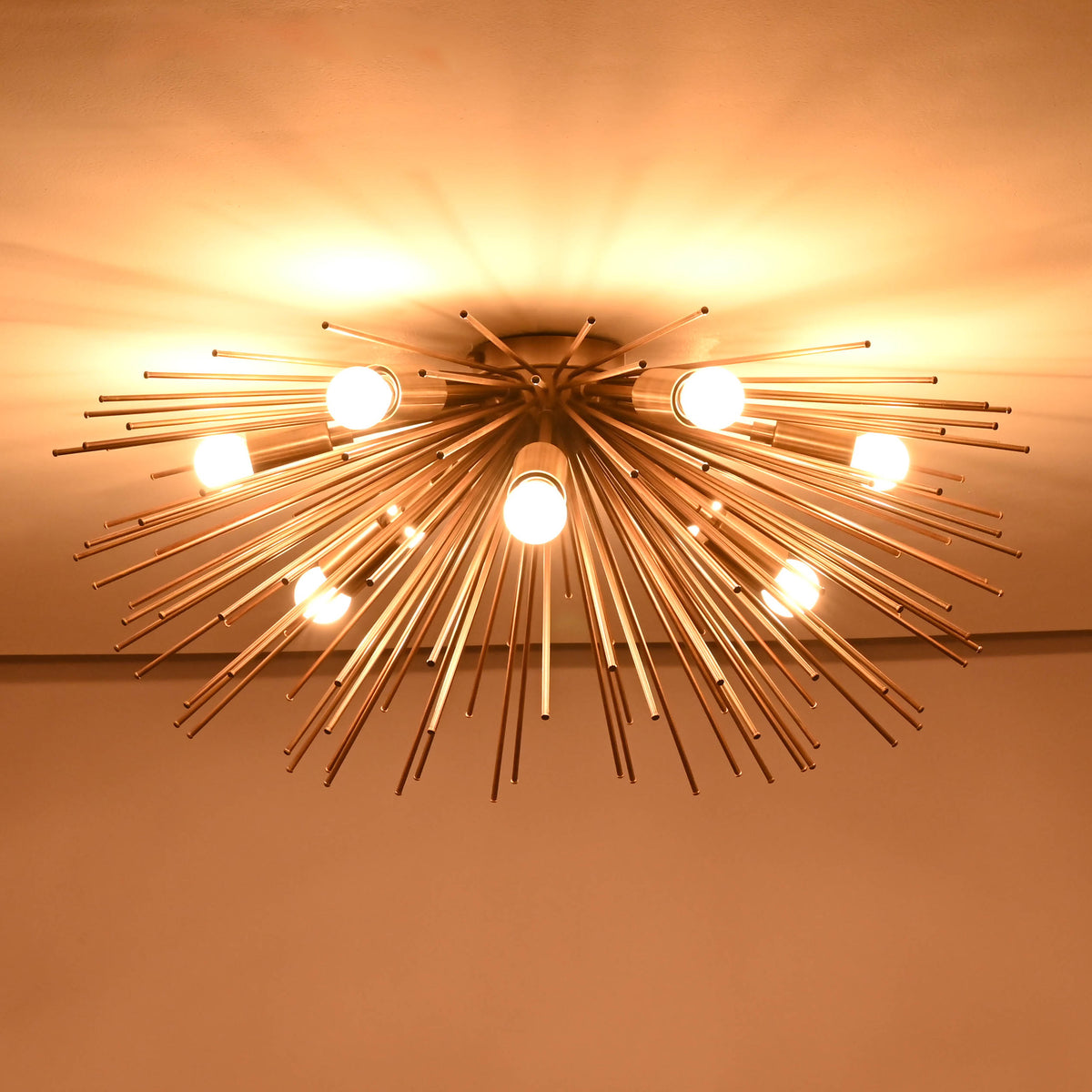 Elegant flushmount chandelier in a sputnik starburst design with brass rods and modern bulbs